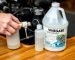 Person using vinegar solution to flush outboard motor cooling system