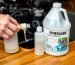 Person using vinegar solution to flush outboard motor cooling system